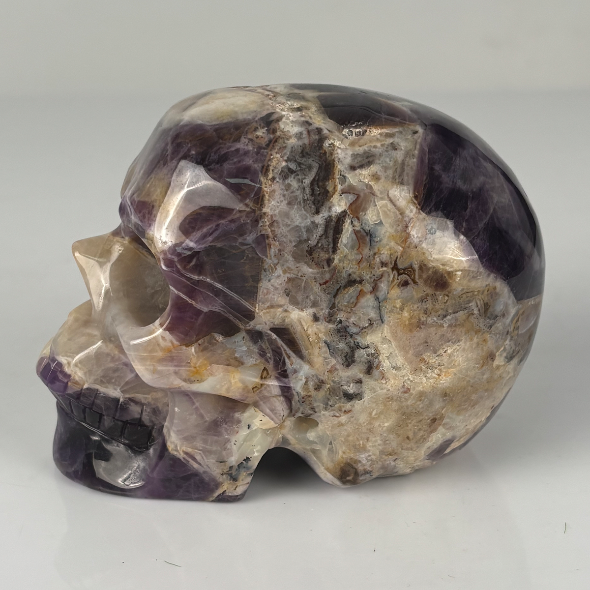 Left view of a 4.5-inch Dream Amethyst human skull carving