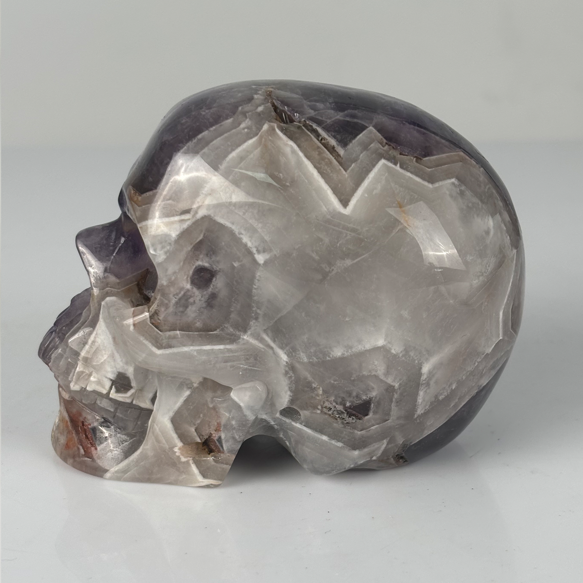 Left view of a 4.5-inch Dream Amethyst human skull carving