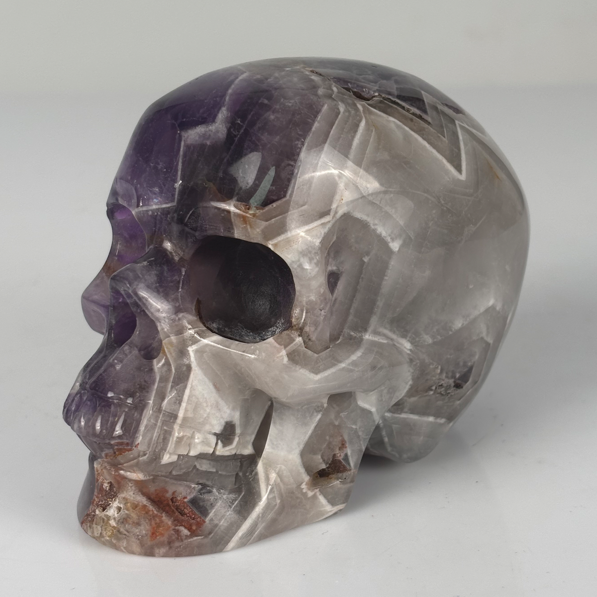 Left-front view of a 4.5-inch Dream Amethyst human skull carving