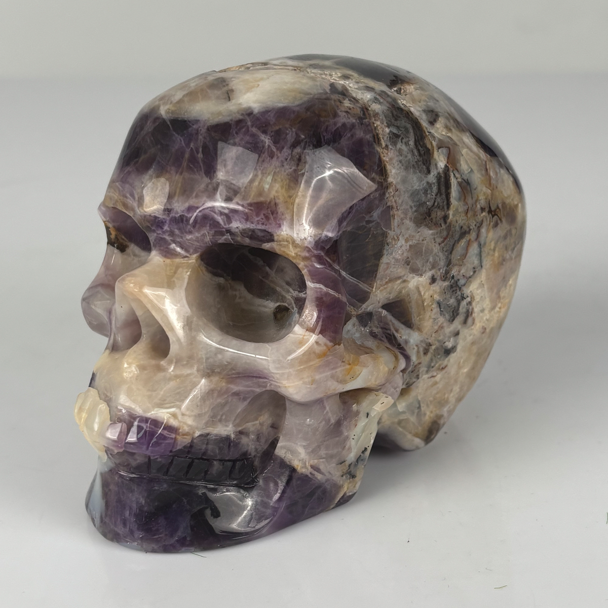 Left-front view of a 4.5-inch Dream Amethyst human skull carving