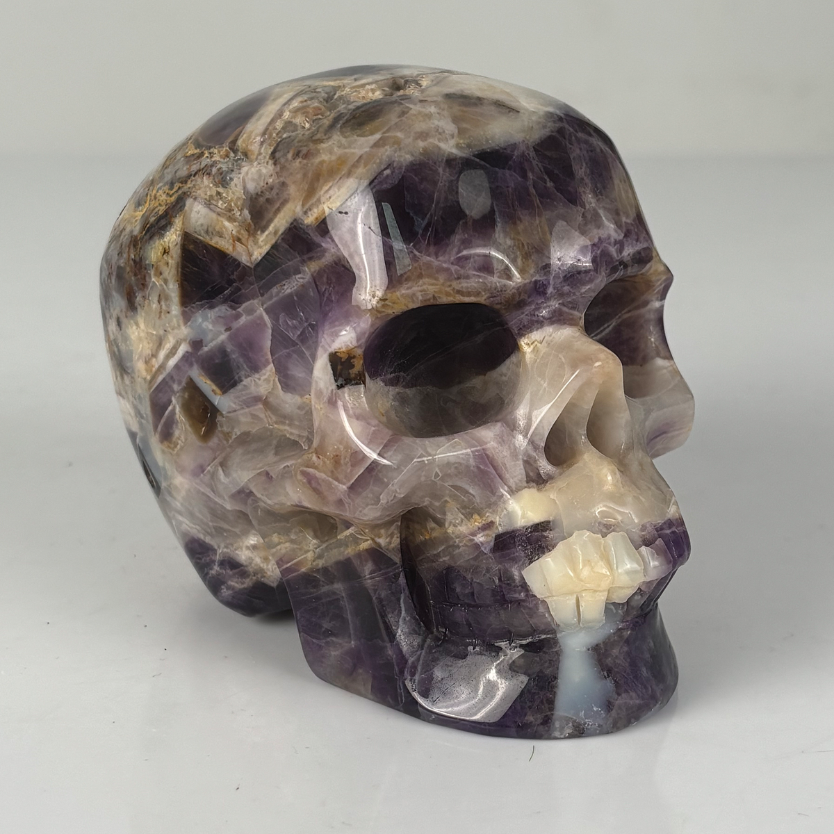 Right-front view of a 4.5-inch Dream Amethyst human skull carving