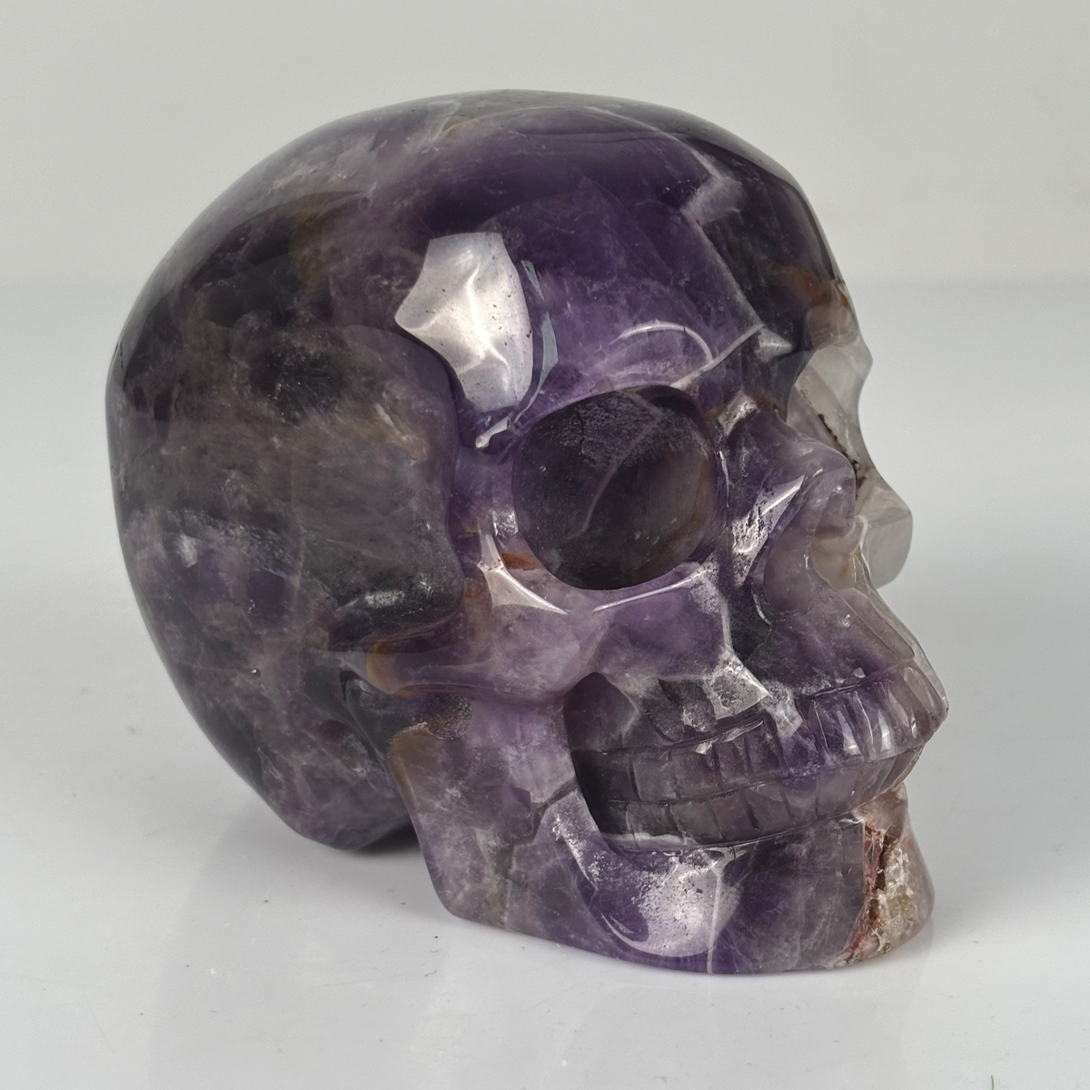 Right-front view of a 4.5-inch Dream Amethyst human skull carving