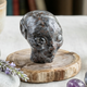 Additional view of a 3-inch Fire Stone alien skull carving