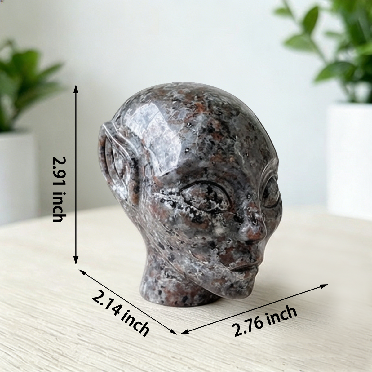 Additional view of a 3-inch Fire Stone alien skull carving
