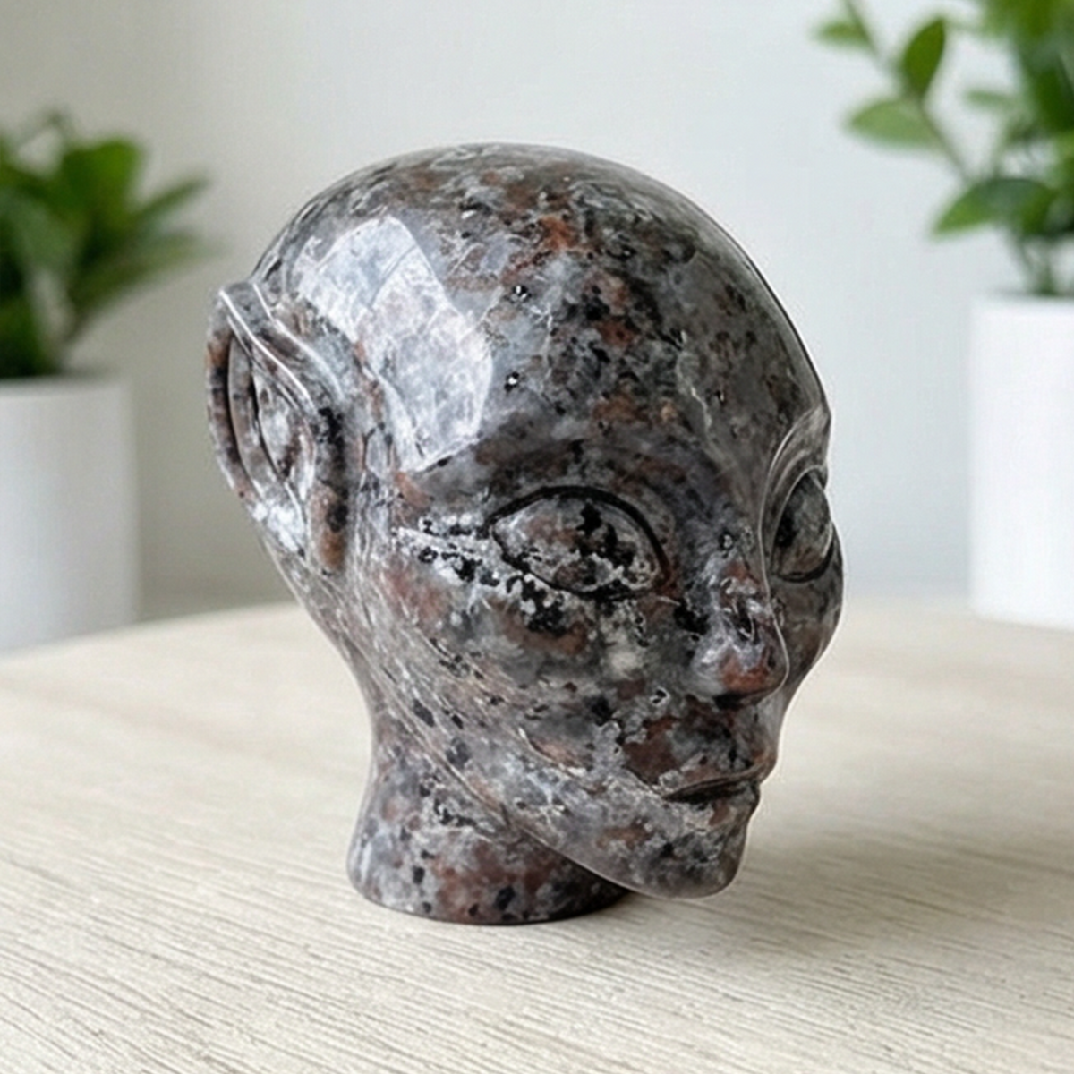 Additional view of a 3-inch Fire Stone alien skull carving