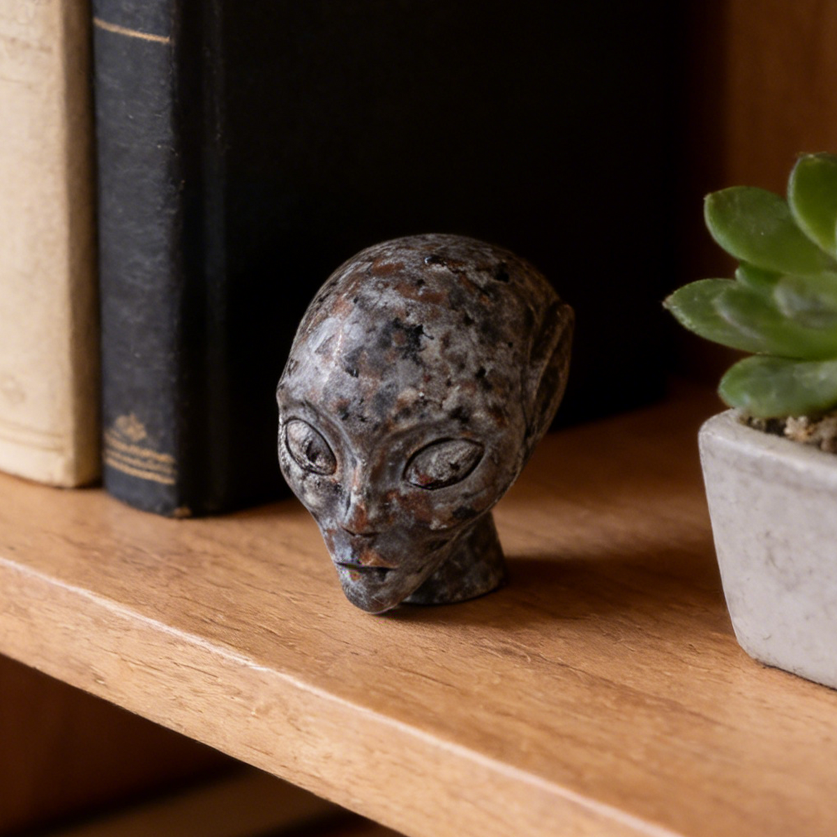Additional view of a 3-inch Fire Stone alien skull carving