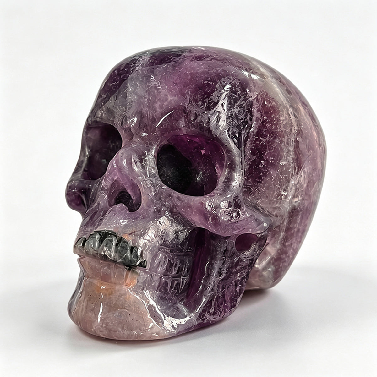 Left-front view of a 2-inch Fluorite human skull carving