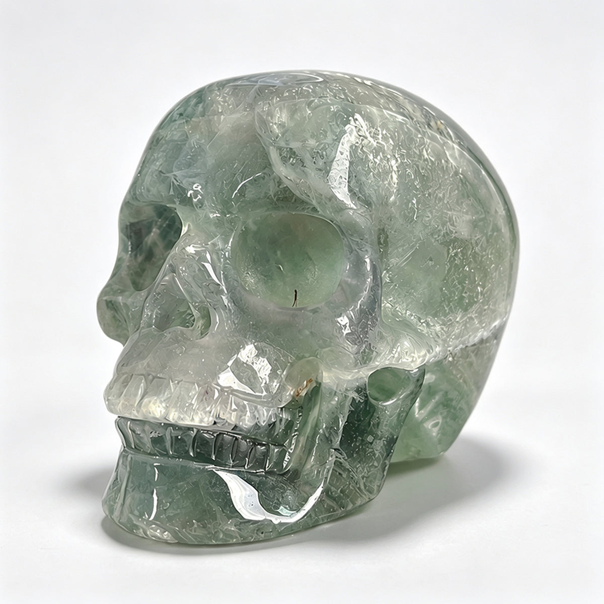 Left-front view of a 2-inch Fluorite human skull carving
