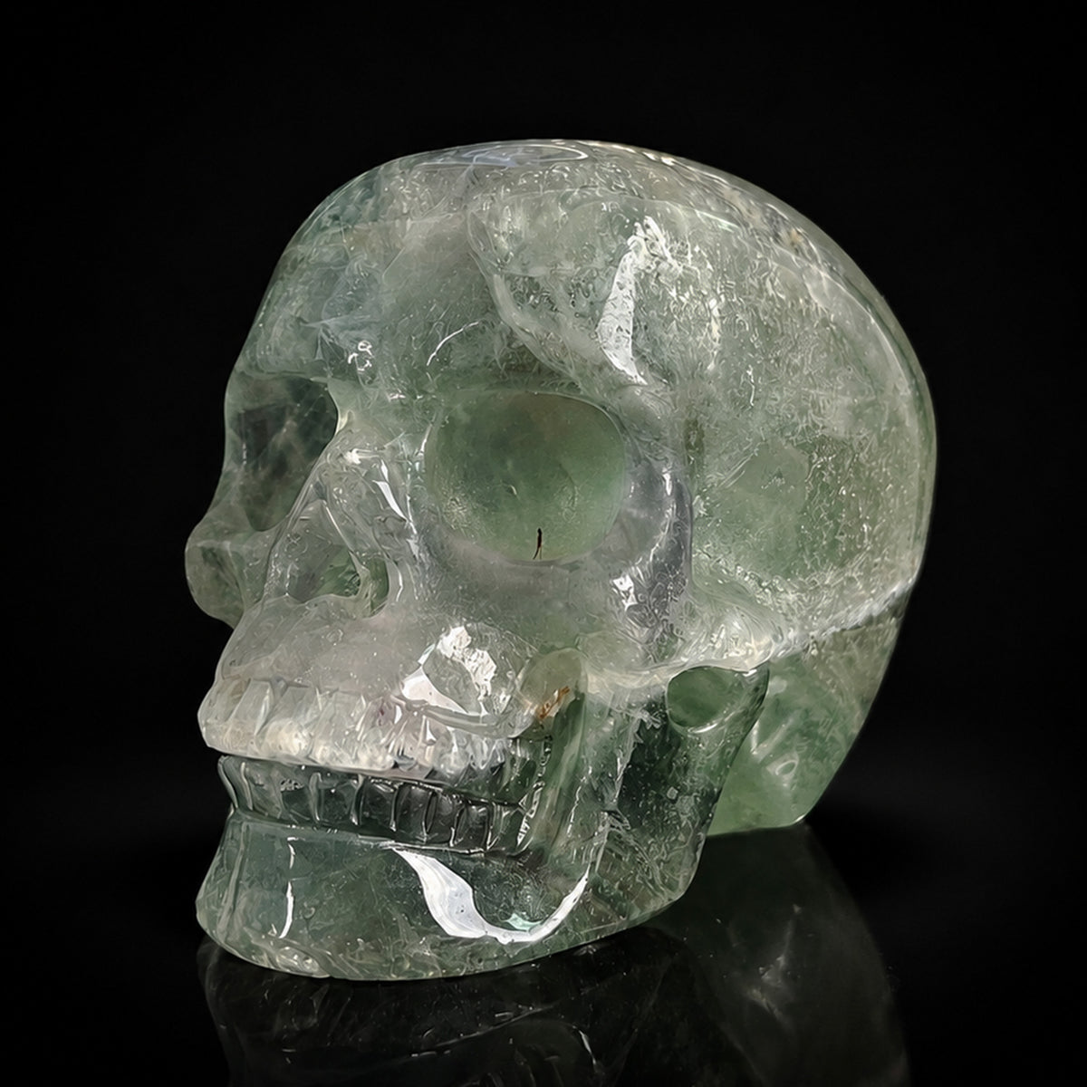 Left-front view of a 2-inch Fluorite human skull carving