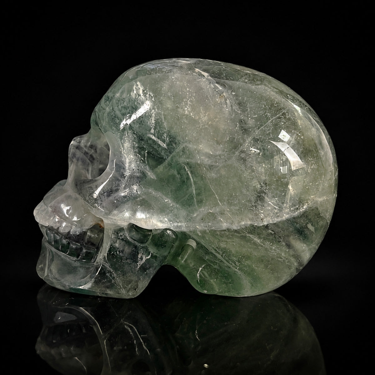 Left-side view of a 2-inch Fluorite human skull carving