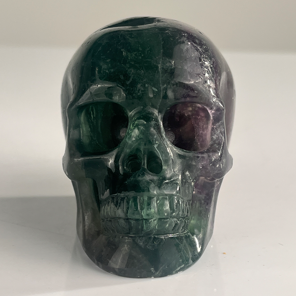 Front view of a 3-inch Fluorite human skull carving