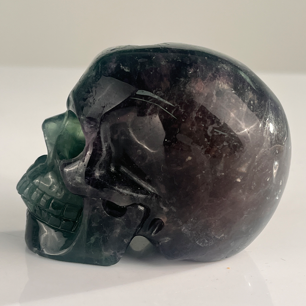 Left view of a 3-inch Fluorite human skull carving