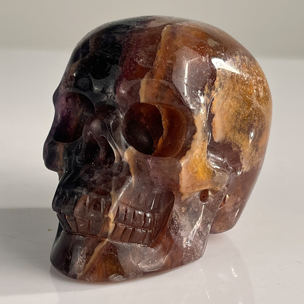 Left-front view of a 3-inch Fluorite human skull carving