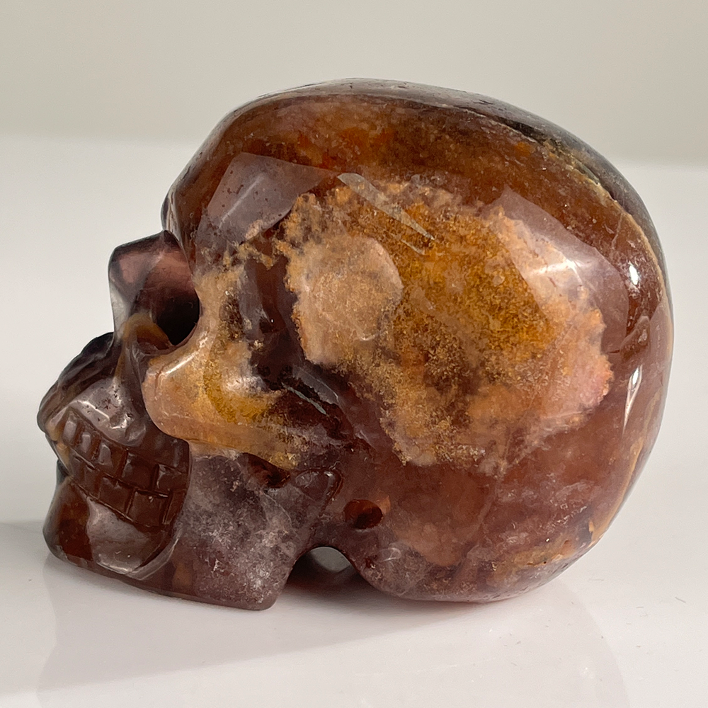 Left-side view of a 3-inch Fluorite human skull carving