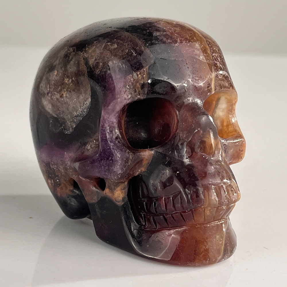 Right-front view of a 3-inch Fluorite human skull carving