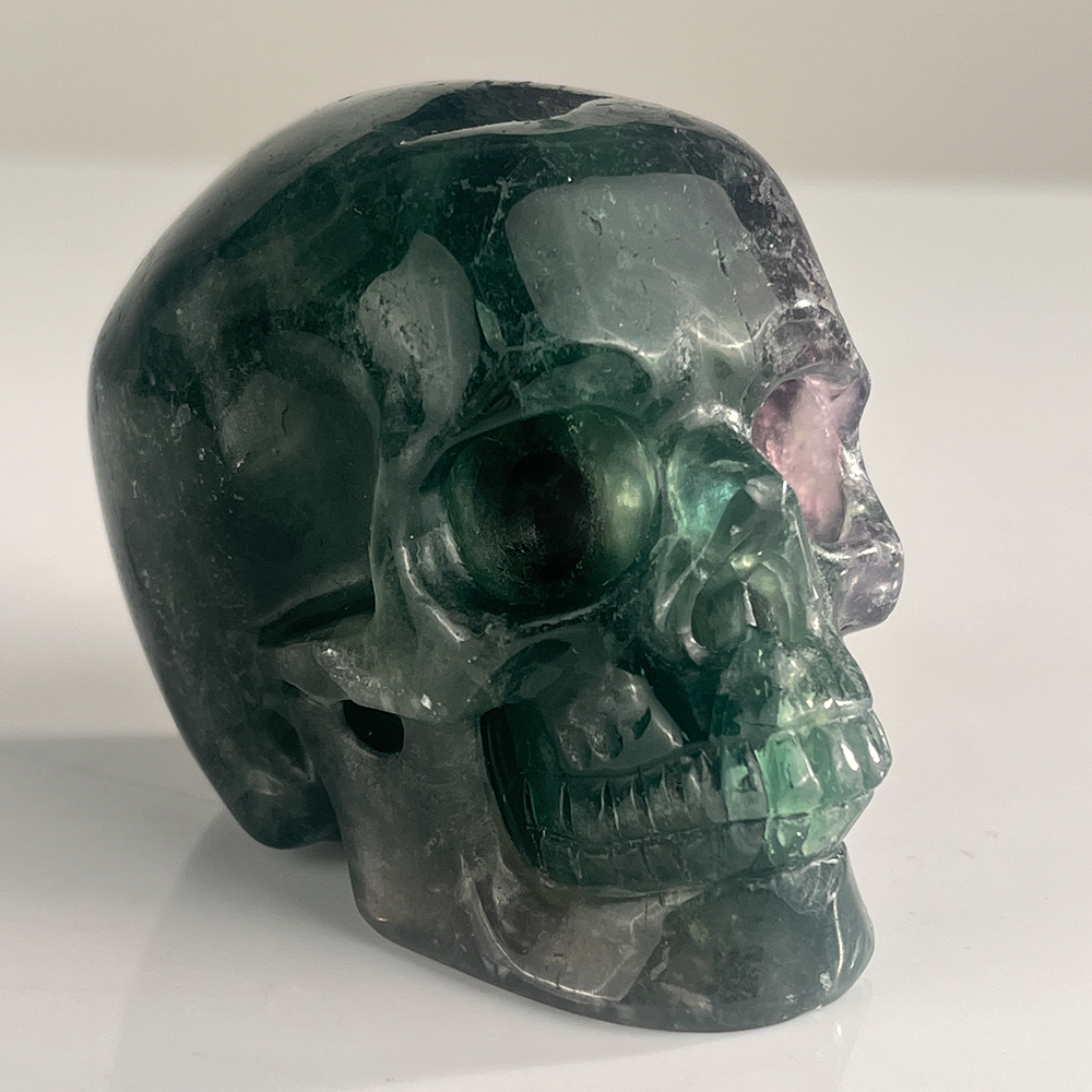 Right-front view of a 3-inch Fluorite human skull carving