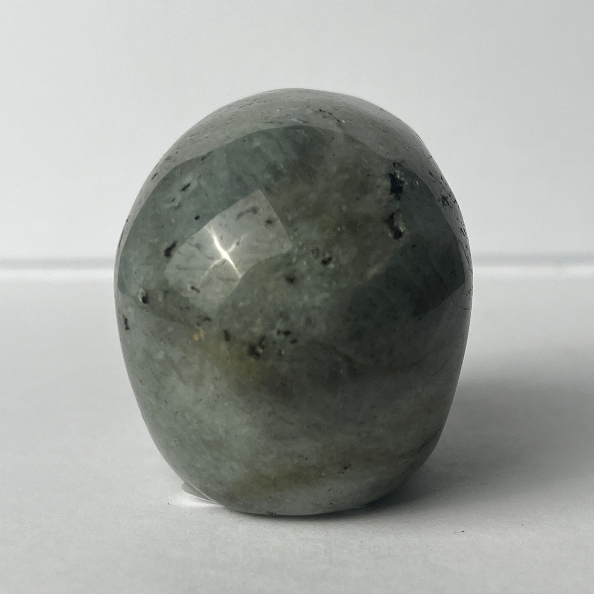 Back view of a 2-inch Grey Labradorite human skull carving