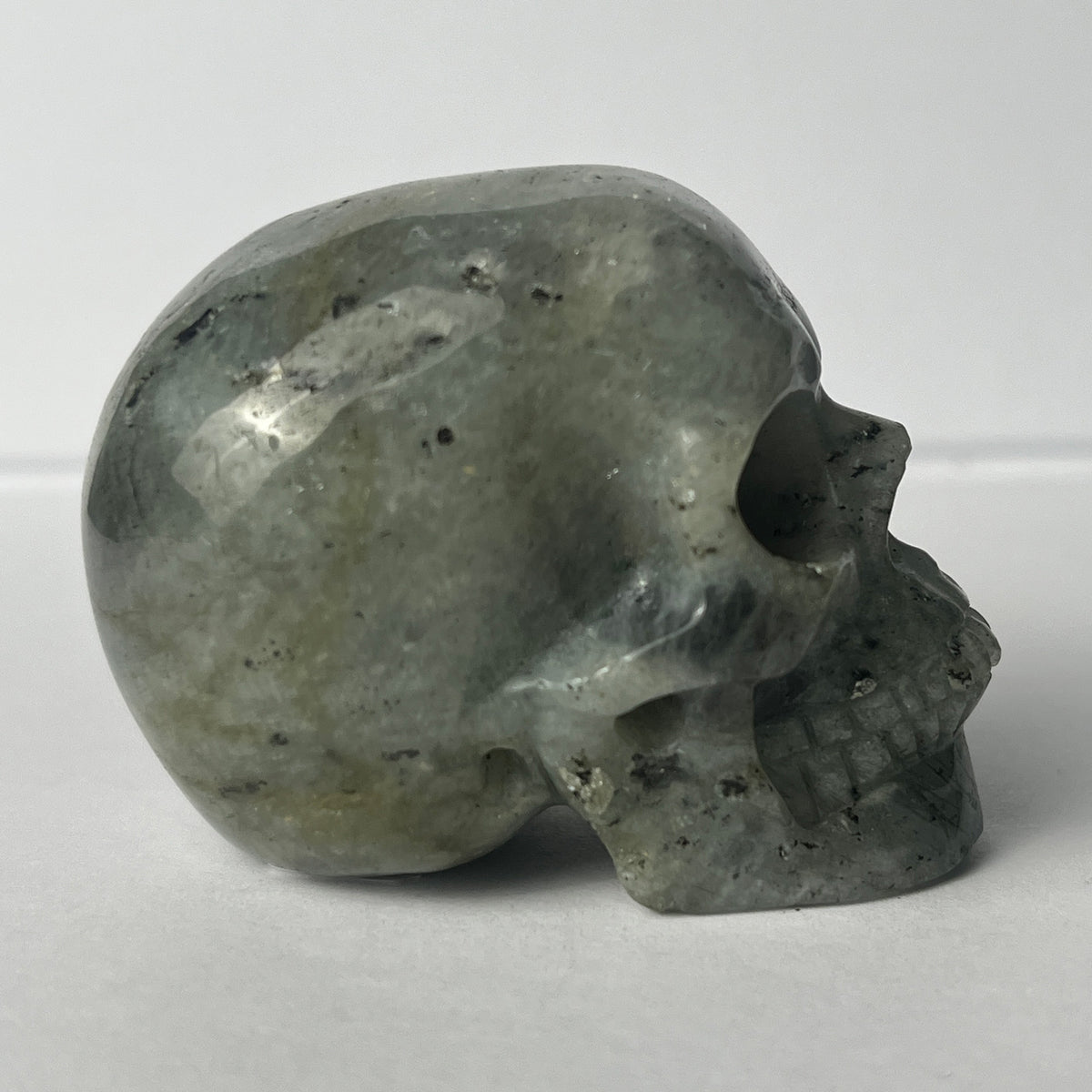 Right view of a 2-inch Grey Labradorite human skull carving