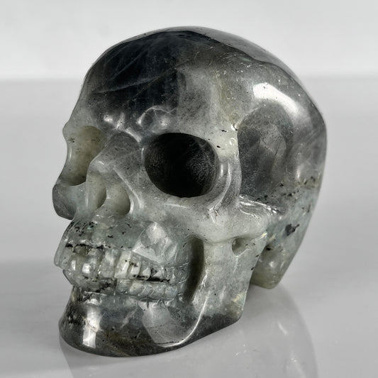 Left-front view of a 3-inch Grey Labradorite human skull carving