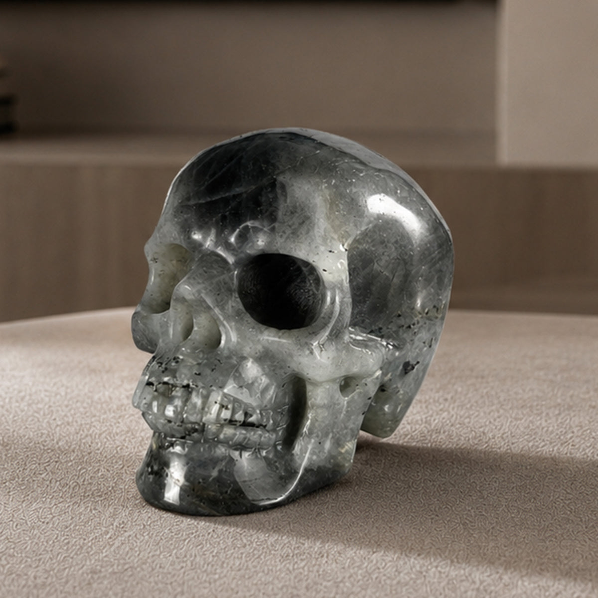 Main view of a 3-inch Grey Labradorite human skull carving