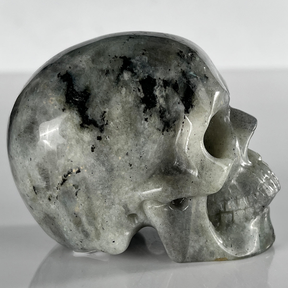 Right view of a 3-inch Grey Labradorite human skull carving