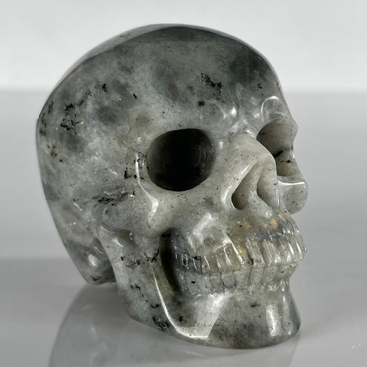 Right-front view of a 3-inch Grey Labradorite human skull carving