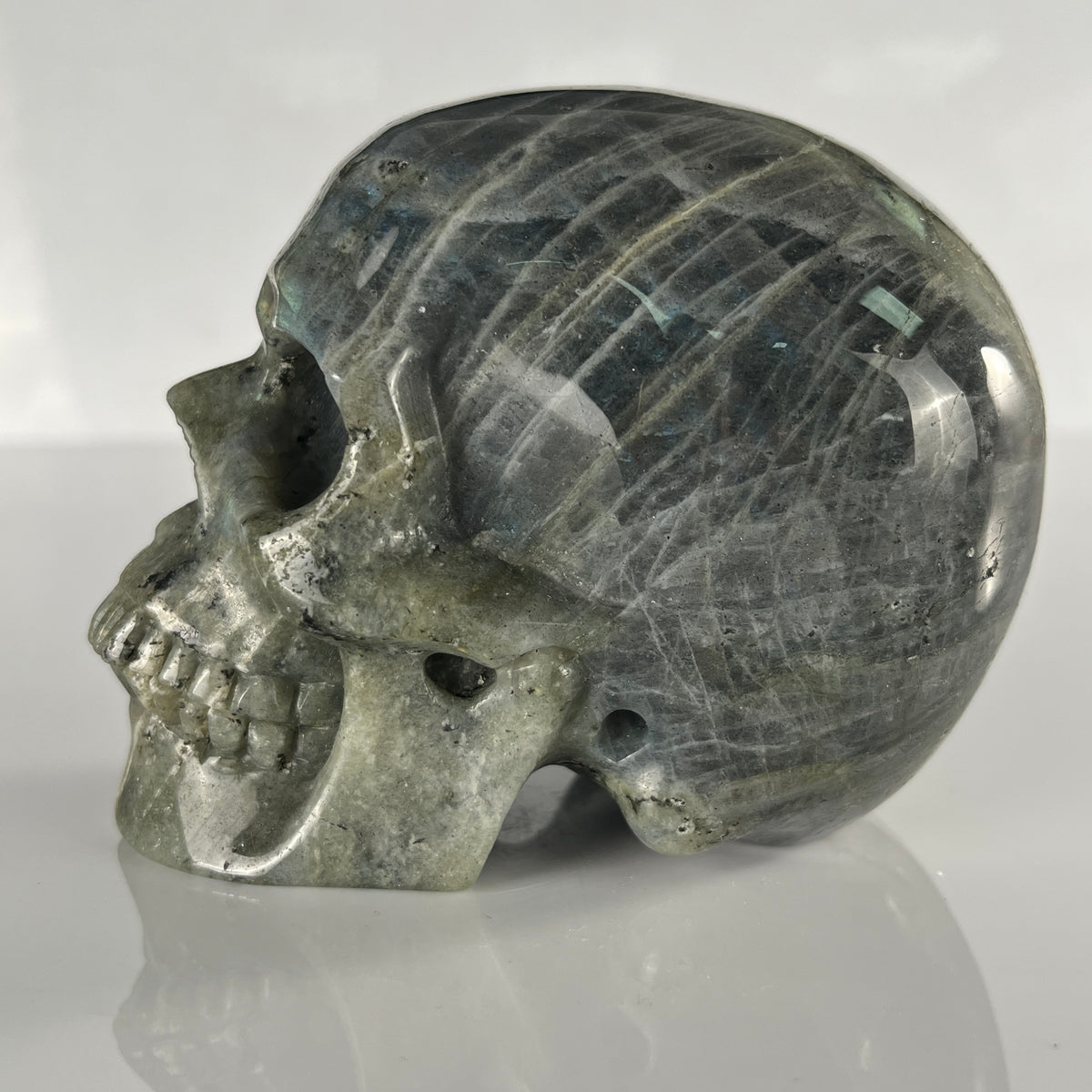 Left view of a 4.5-inch Grey Labradorite human skull carving