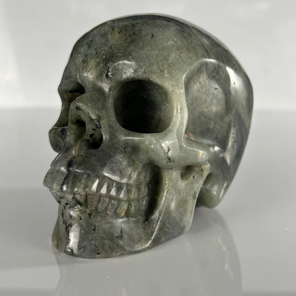 Left-front view of a 4.5-inch Grey Labradorite human skull carving