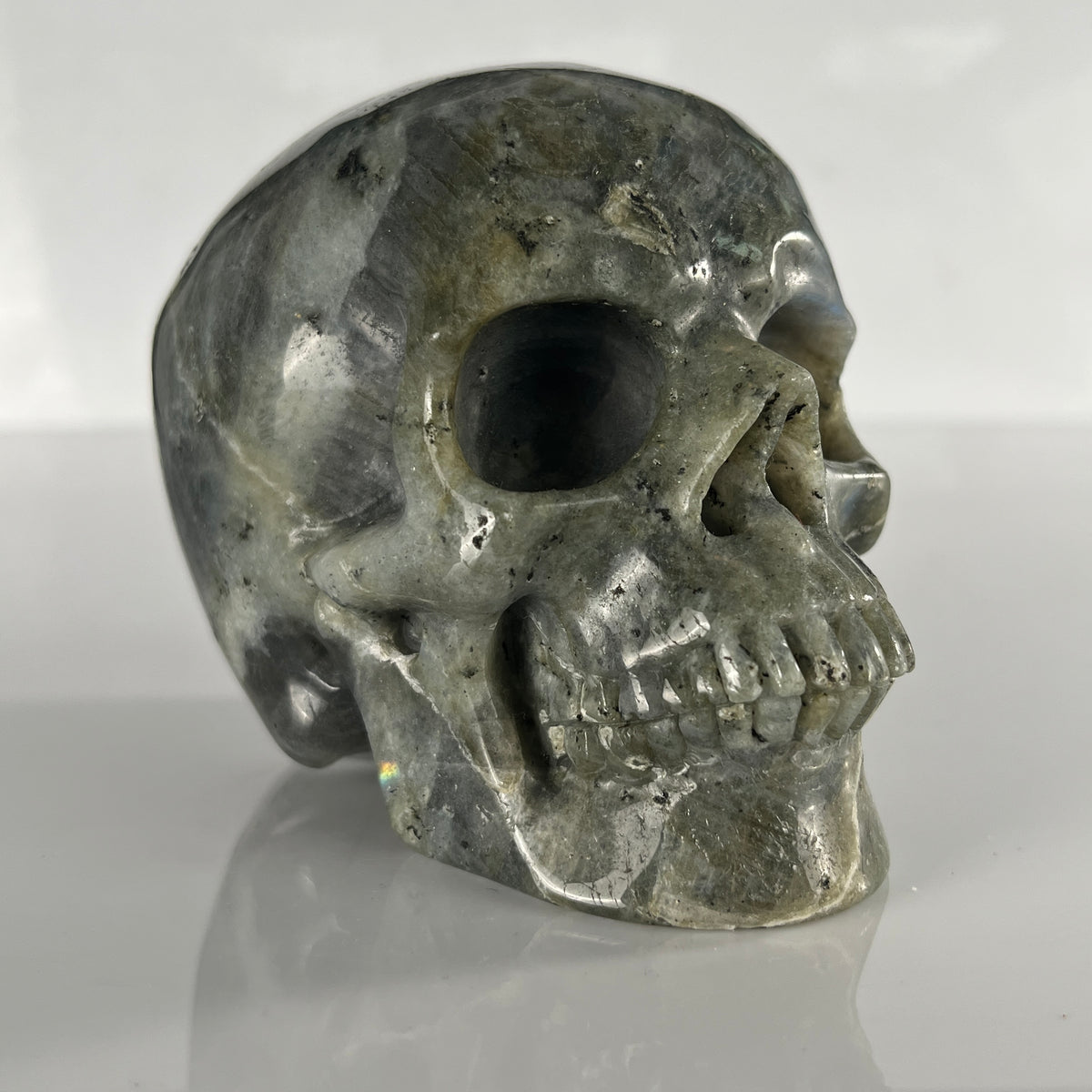 Right-front view of a 4.5-inch Grey Labradorite human skull carving