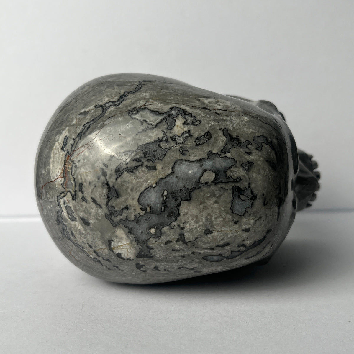 Top view of a 4.5-inch Grey Picture Jasper human skull carving