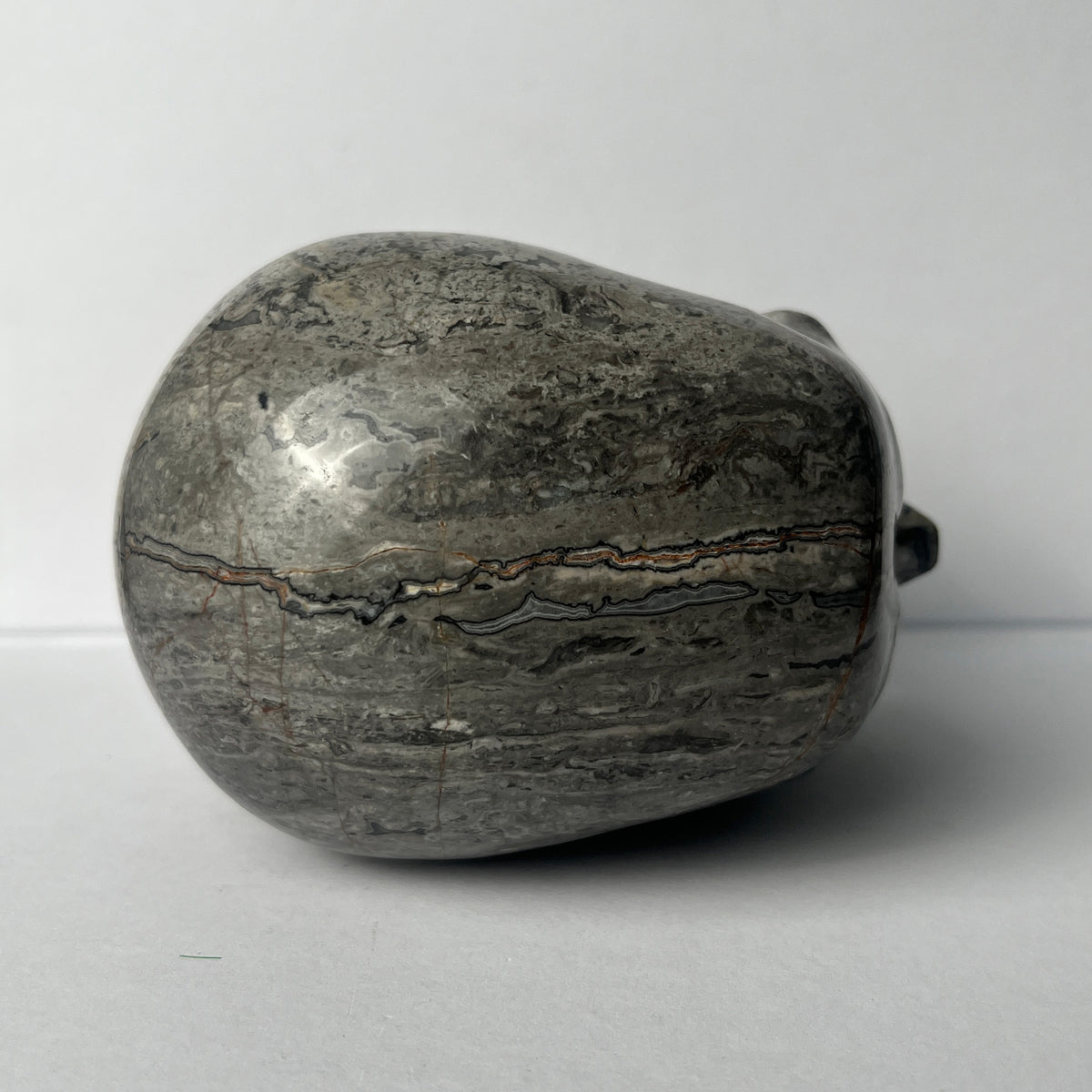 Top view of a 4.5-inch Grey Picture Jasper human skull carving