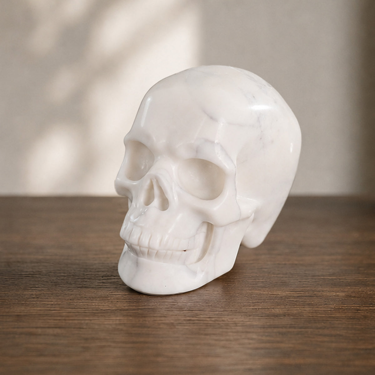 Left-front view of a 2-inch Ivory Jade human skull carving