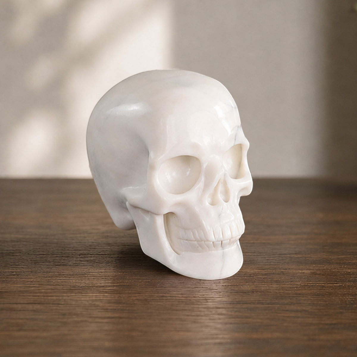 Right-front view of a 2-inch Ivory Jade human skull carving