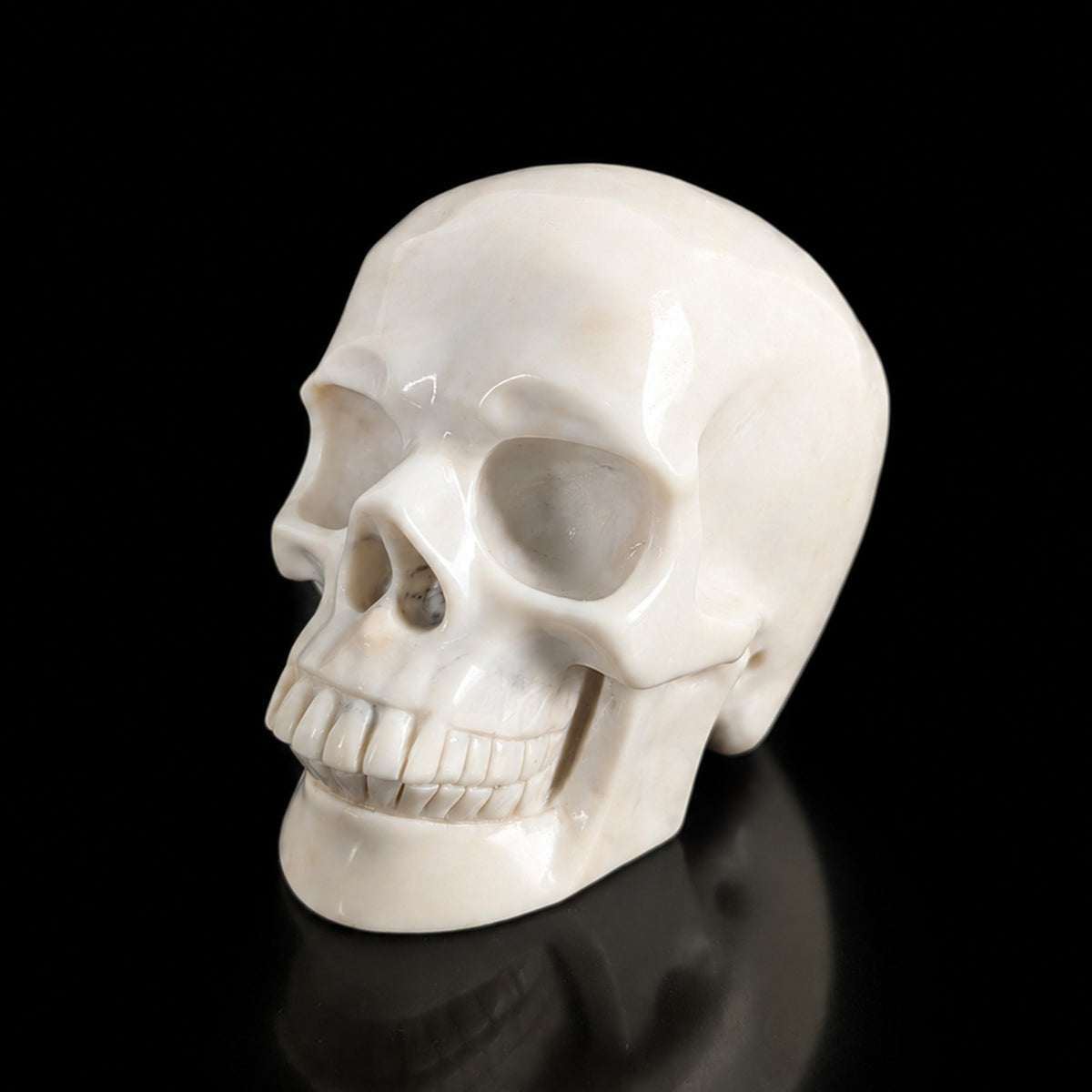 Left-front view of a 4.5-inch Ivory Jade human skull carving