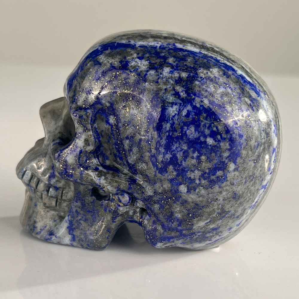 Left view of a 3-inch Lapis Lazuli human skull carving