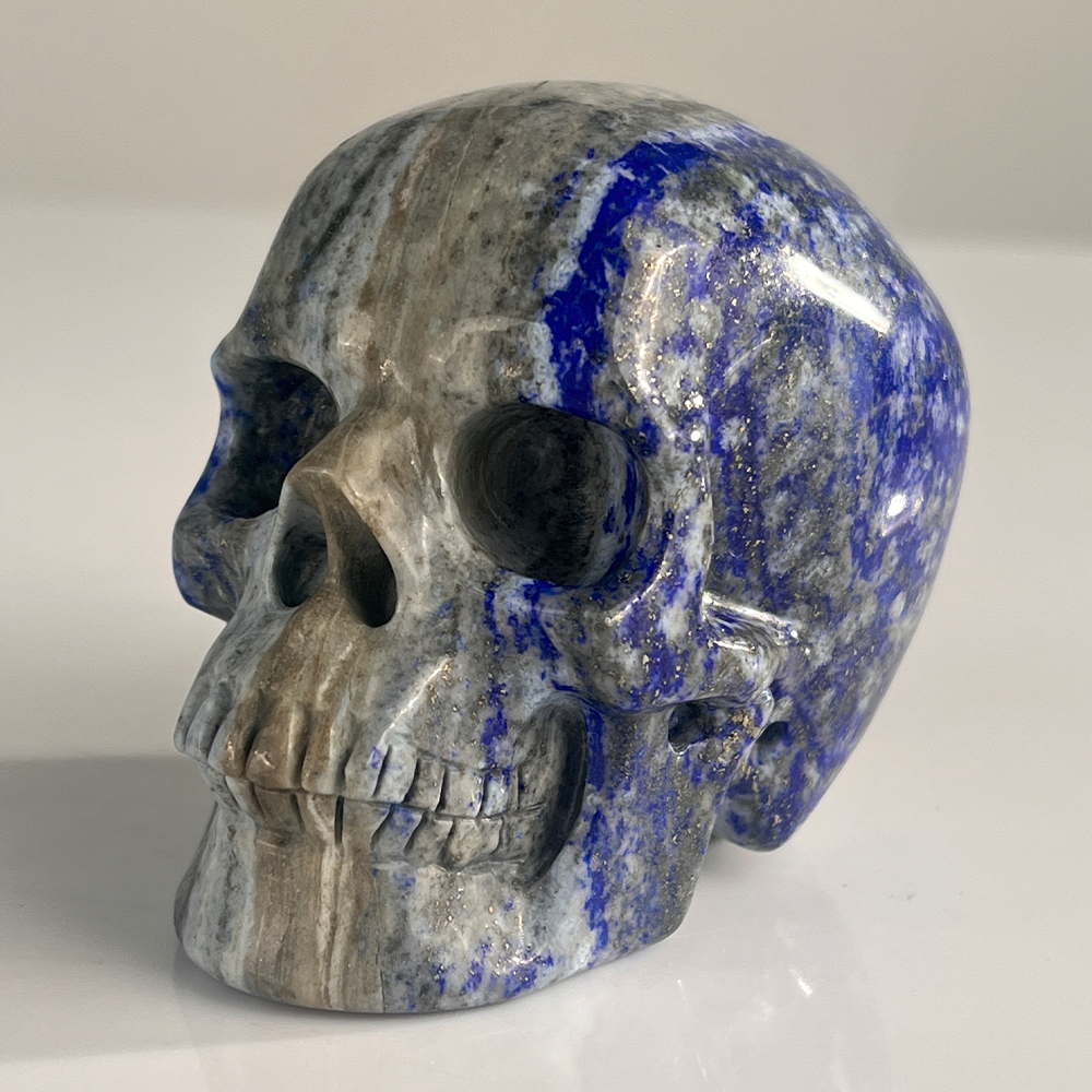 Left-front view of a 3-inch Lapis Lazuli human skull carving