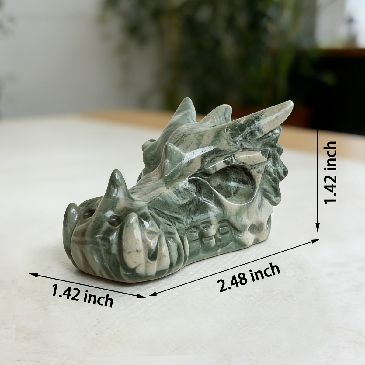 Additional view of a 2.5-inch Nine Dragon Jade dragon skull carving