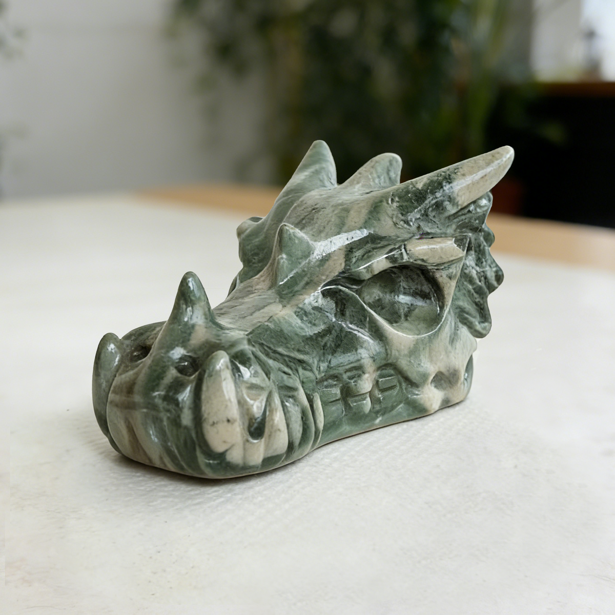 Additional view of a 2.5-inch Nine Dragon Jade dragon skull carving