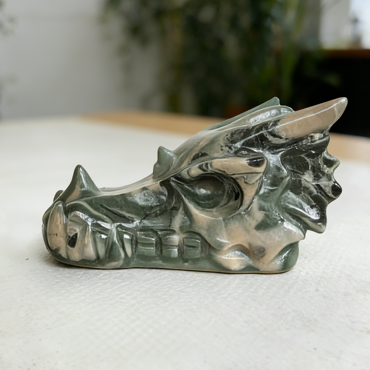 Additional view of a 2.5-inch Nine Dragon Jade dragon skull carving