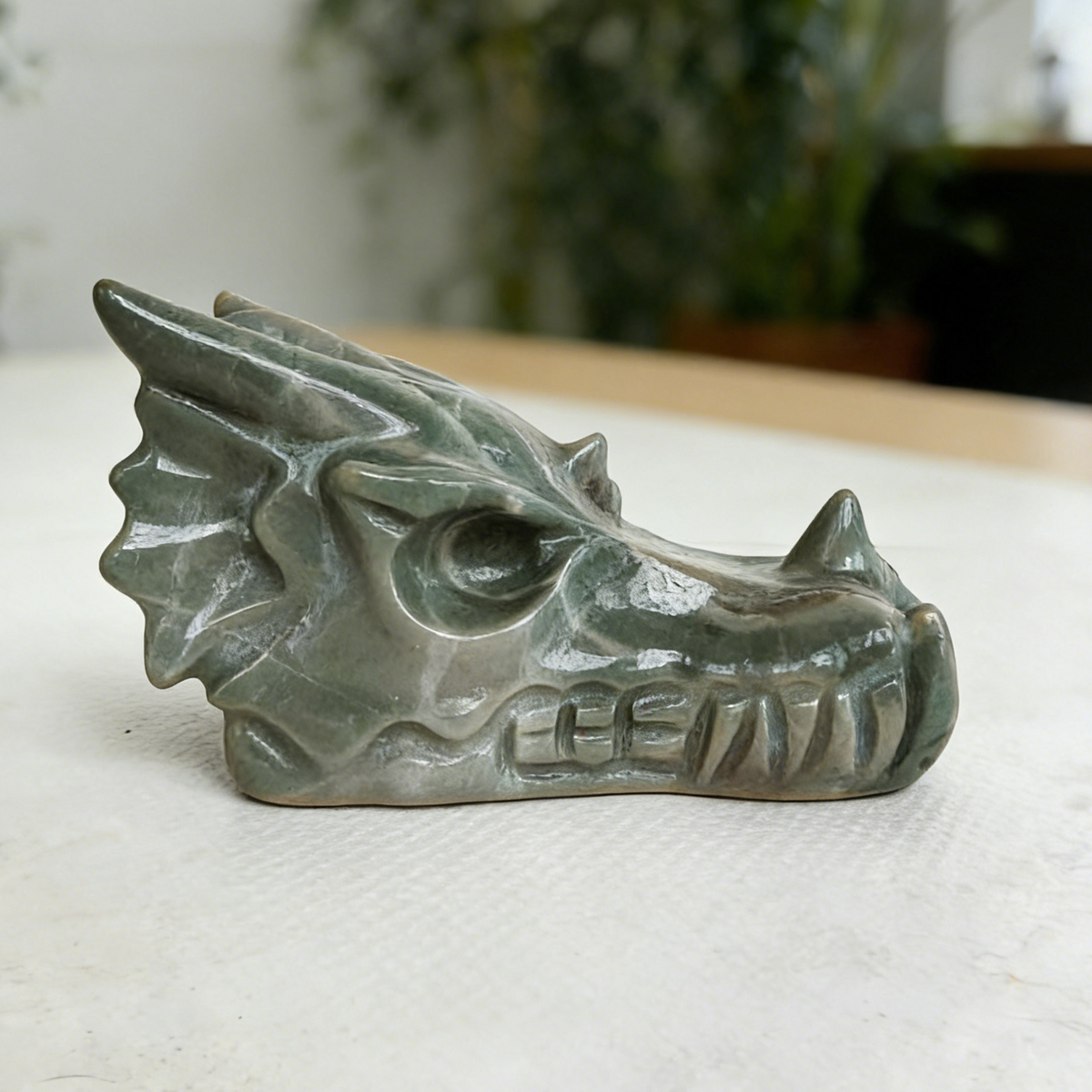 Additional view of a 2.5-inch Nine Dragon Jade dragon skull carving