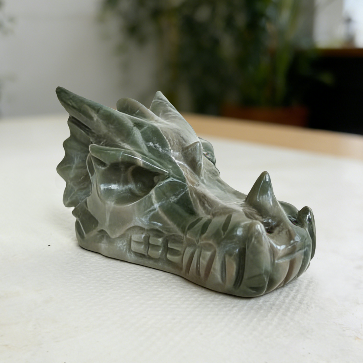 Additional view of a 2.5-inch Nine Dragon Jade dragon skull carving