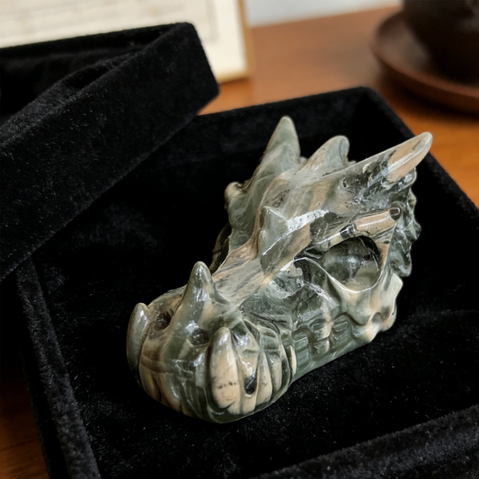 Additional view of a 3-inch Nine Dragon Jade dragon skull carving
