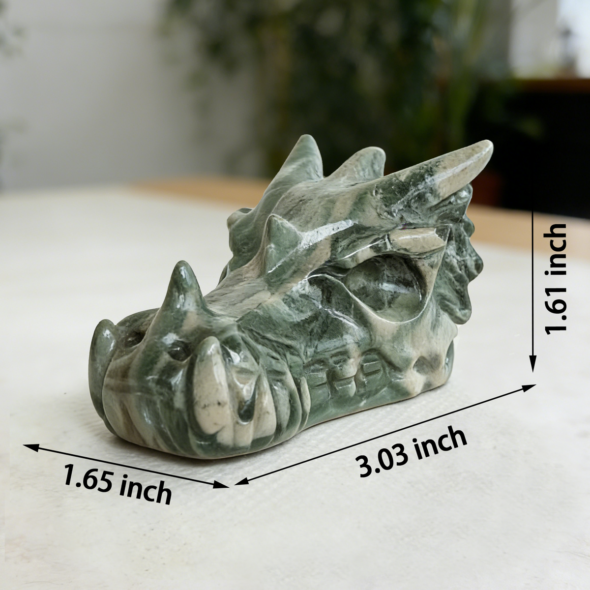 Additional view of a 3-inch Nine Dragon Jade dragon skull carving