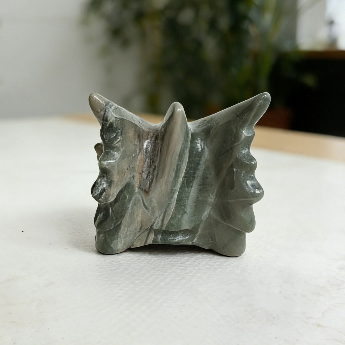 Additional view of a 3-inch Nine Dragon Jade dragon skull carving