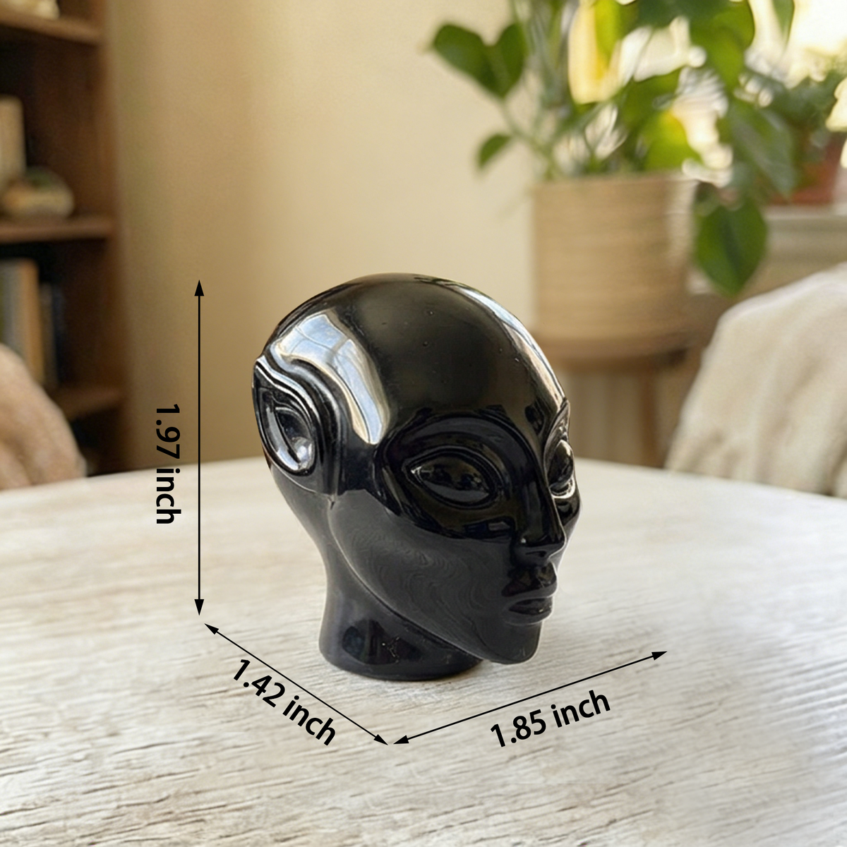 Additional view of a 2-inch Obsidian alien skull carving