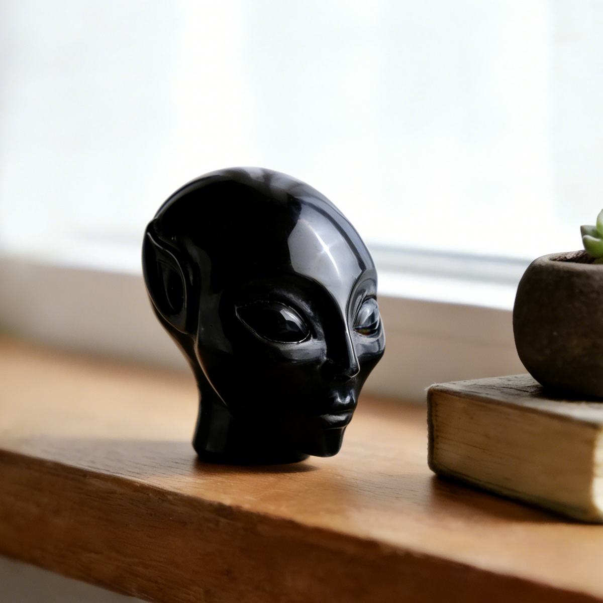 Additional view of a 2-inch Obsidian alien skull carving
