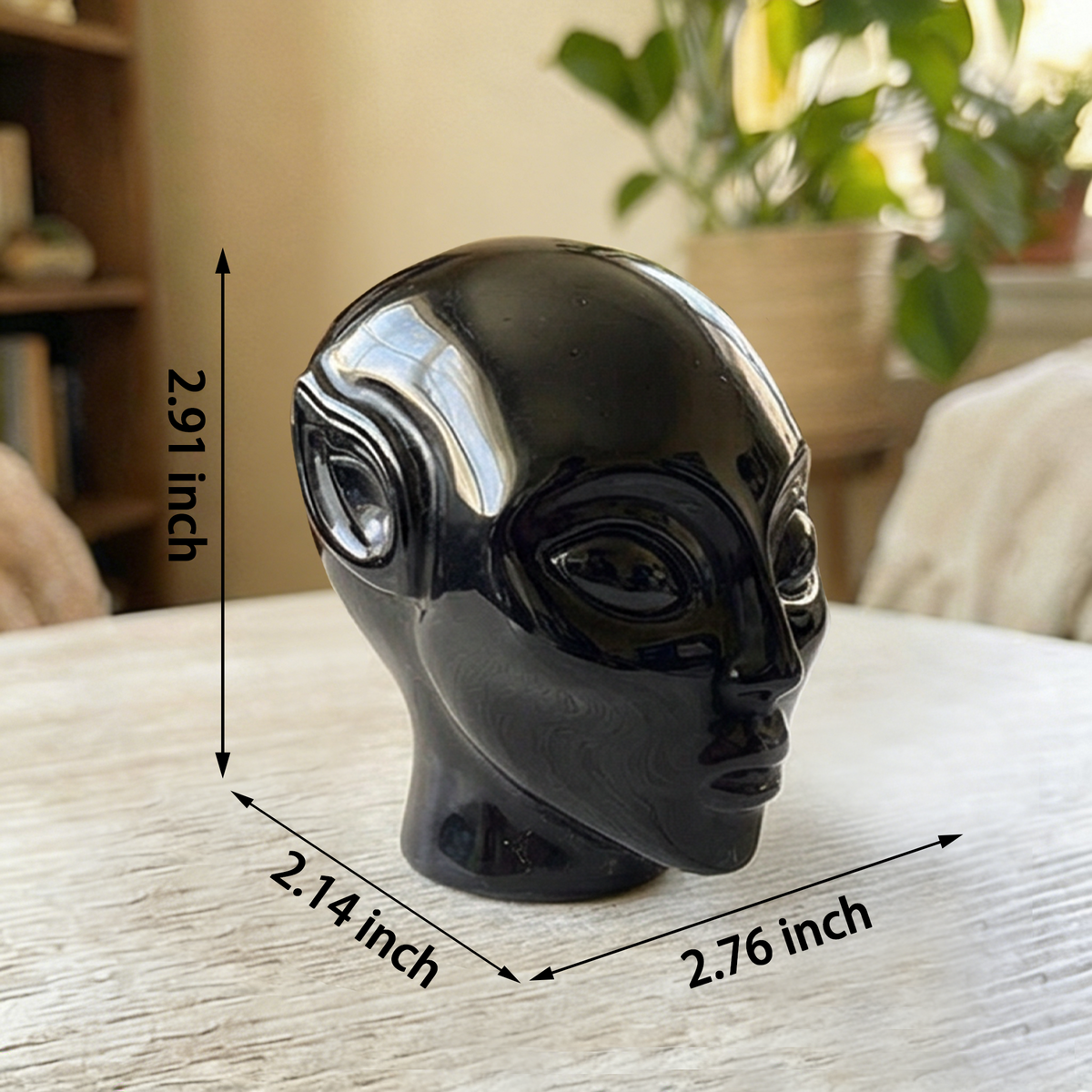 Additional view of a 3-inch Obsidian alien skull carving