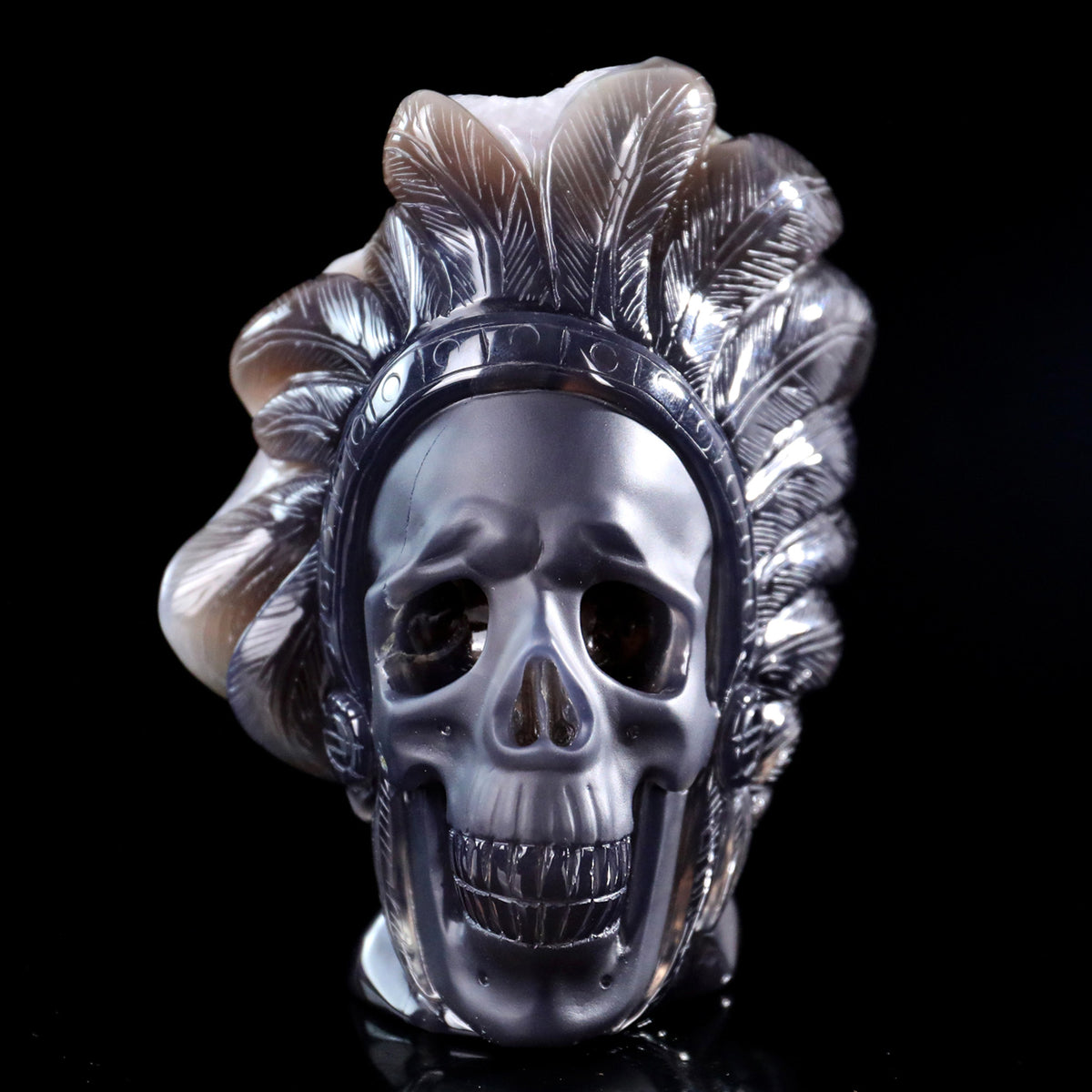 Front view of a one-of-a-kind Amethyst crystal-cluster skull with warbonnet carving