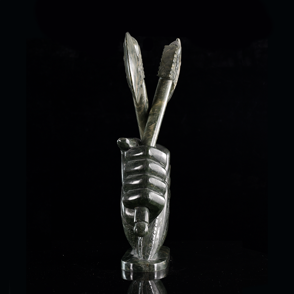 Right view of a one-of-a-kind Nine Dragon Jade armored hands with crossed axes sculpture