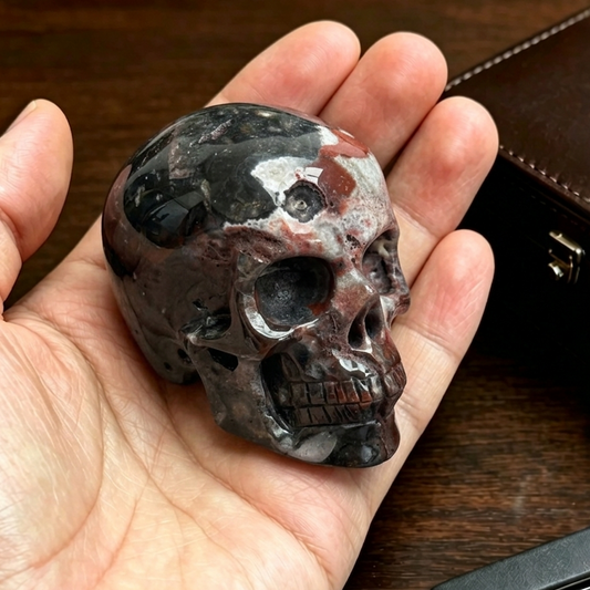 Main view of a 2-inch Red Crazy Lace Agate human skull carving